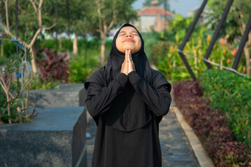 A hijab-wearing woman doing morning exercise