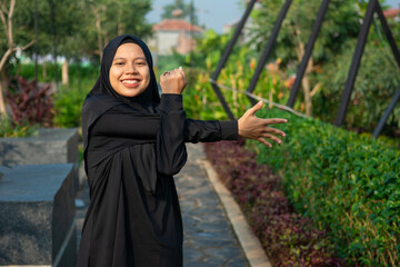 A hijab-wearing woman doing morning exercise