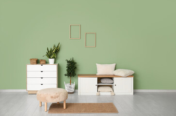 Chest of drawers, sideboard and pouf in room