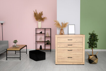 Chest of drawers, pouf, shelving unit and coffee table in living room