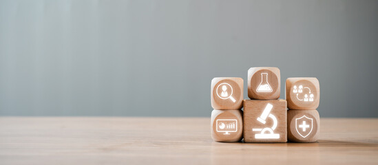 Wooden blocks with medical and research icons representing clinical study concepts on a wooden...