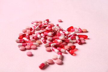 Different pills on pink background, closeup