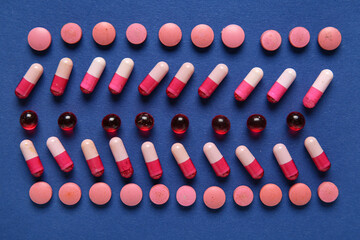 Different pills on blue background, closeup
