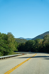 A winding road with view of mountains in White Mountain National Forest.