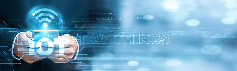 Internet of things.Businessman using mobile smartphone and IOT icon network connection to monitor data with growth projections, predictive maintenance, smart logistics, and connected devices.