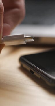 USB-C cable macro plugin to smartphone slow motion, vertical view