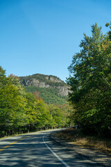 A winding road with view of mountains in White Mountain National Forest.