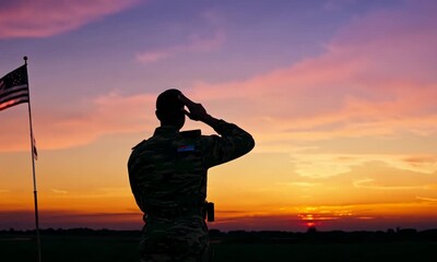 Silhouette of a Soldier Saluting Against a Sunset