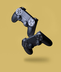 Flying air gamepads from a game console on a yellow background. The concept of games © showcake