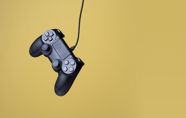 Flying air gamepads from a game console on a yellow background. The concept of games