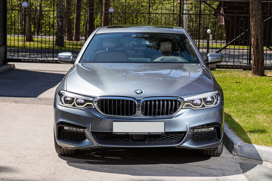 Novosibirsk, Russia -  July 10, 2024: BMW 5-series, parked in city. No other car and people.