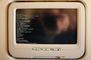 Passenger airplane console screen displaying Linux terminal.