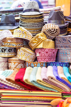 Traditional hats and textiles in the old souk of Mutrah, Muscat, Oman