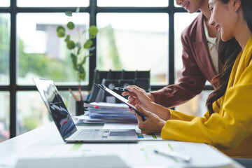 Two young businesswomen in conversation Exchange ideas, present analysis of marketing and investment plans on data files. Document assignment Explaining business accounting concepts online marketing.