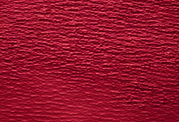 A smooth, abstract background featuring a gradient of deep red hues with subtle textures. A close-up view, create a dynamic pattern. The rich red color adds depth and warmth to the image.