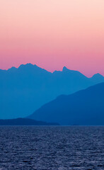 Colorful Sunrise on West Coast of Pacific Ocean with Islands and Canadian Mountain Landscape.