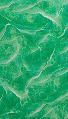 Fototapeta premium An abstract pattern of green waves resembling water surface, with a textured appearance a vibrant green color with a marbled effect, resembling jade. The light creates movement in the design.