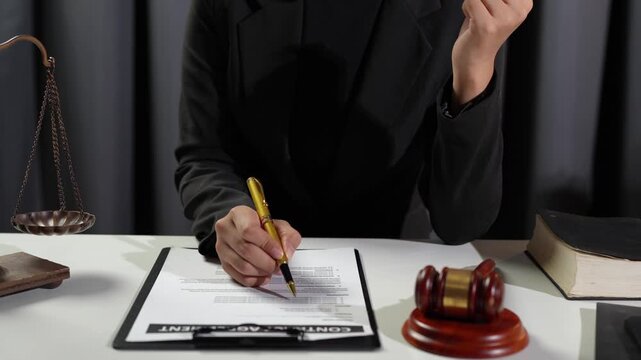 Lawyer, legal advisor Young businessman pointing at pen and reading agreement details Business contract for validity before signing financial contract inside office.