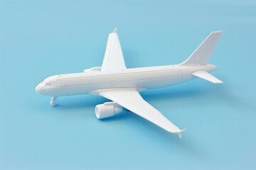  Minimalist white airplane toy model on pastel blue background with copy space
