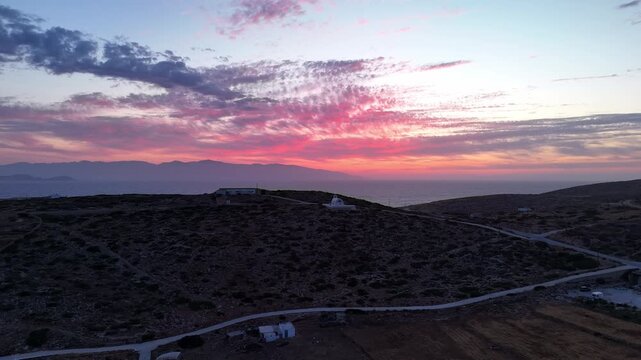 Panoramic aerial establishing dolly to Holy Wisdom church in Donousa Greece at sunset