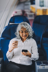 business woman sitting inside plane at the airport with sky view from the window drinking a cup of coffee