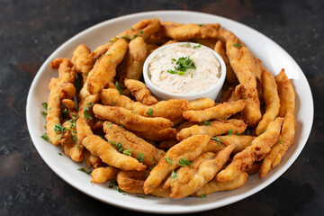 Fried chicken strips with tartar sauce, a typical Brazilian bar dish. bar snack. Comida de boteco