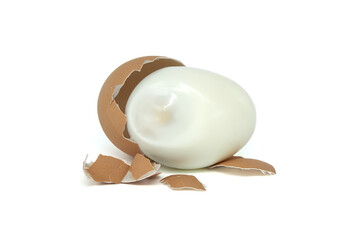 Egg, mostly peeled, against a white background