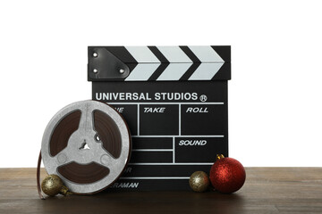PNG, Clapperboard, reel and Christmas balls on table, isolated on white background