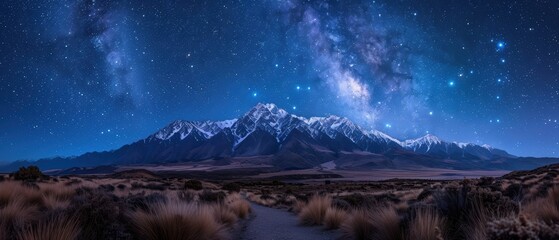 Majestic Snow-Capped Mountain Range under Starry Night Sky in