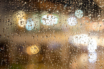 Rain drops on the glass with Bokeh. Window glass with raindrops as background.