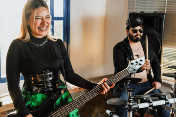 Band rehearsing at home. Electric drums, microphone, bass and guitar. International music day.