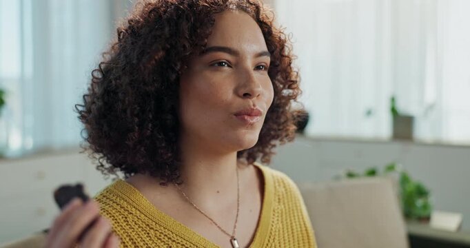 Happy woman, eating and chocolate bar in home for dessert, comfort food and relax in lounge or living room. Female person, sugar high and smile for enjoying sweets, snack and cacao craving with candy