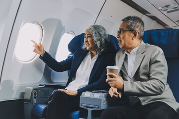 Happy elderly senior couple of travelers with suitcase in airport
