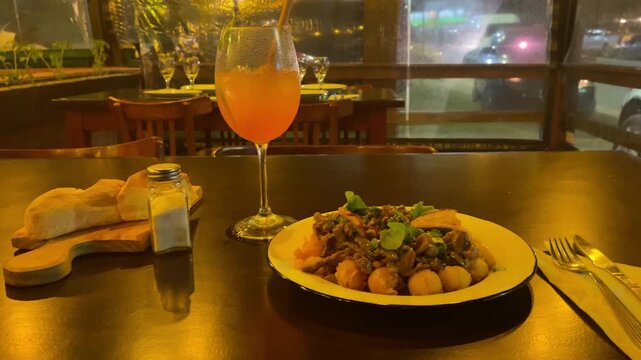 traditional dish in argentina meat and mashrooms stroganoff with potato ball food on plate in cafe amateur shot