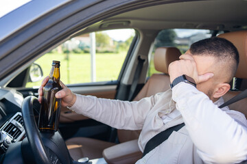 man drinking alcohol while driving the car. Don't drink and drive concept. . High quality photo