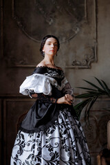 A caucasian woman, mid-30s, exudes aristocratic grace in a richly embroidered Baroque gown. Ideal for fashion editorials, historical romance book covers, or interior design concepts.