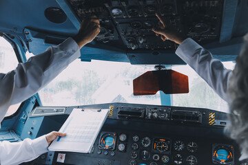 Professional pilot woman in uniform has teamwork meeting for success flight in aviation business. Young female captain instructor sitting in office and working or training commercial airline crew.