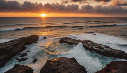Obraz premium Stunning Coastal Sunset with Rocky Cliffs and Waves