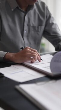 Auditor reading a report documents in office