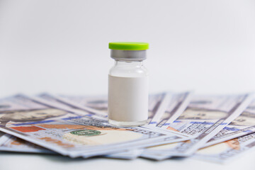 A vial on the fake money. Medical conceptual.