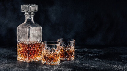 Glasses of the whiskey with a square decanter