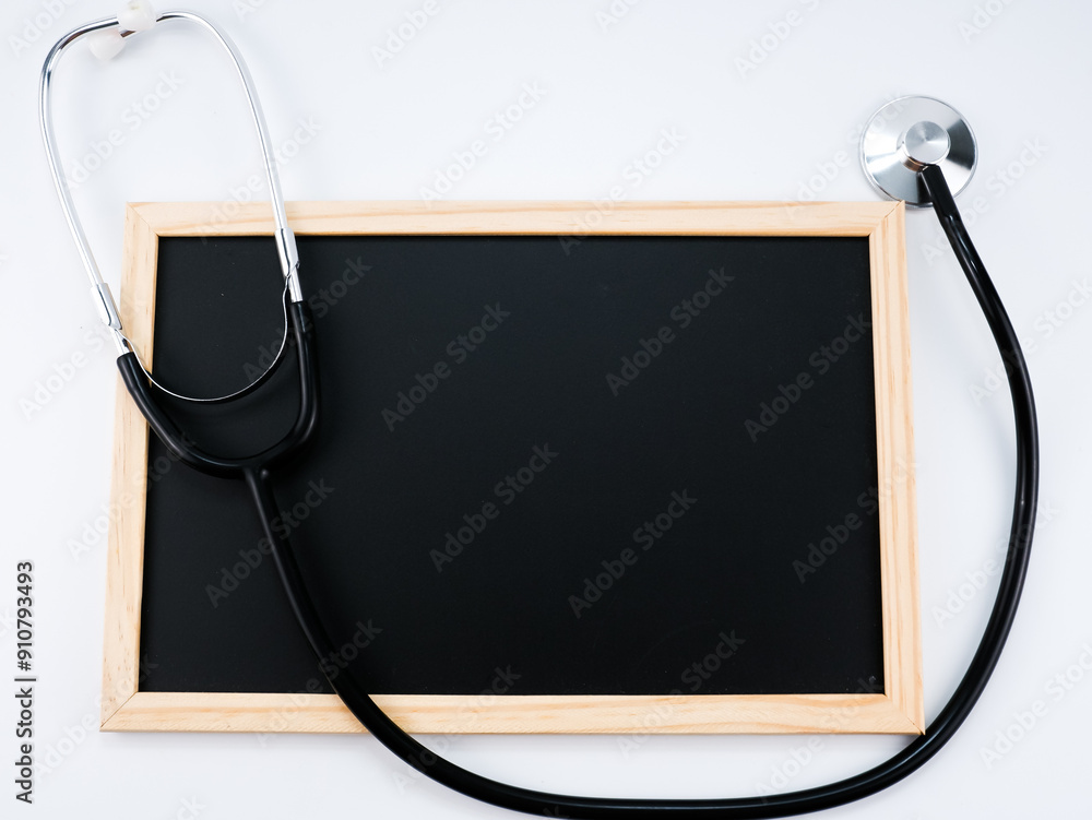 Wall mural a blackboard and stethoscope isolated with white background.