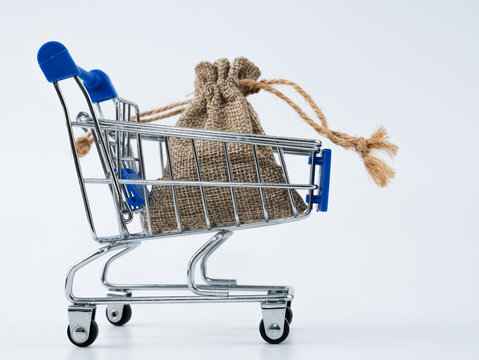 A burlap sack in the cart. Isolated with white background.