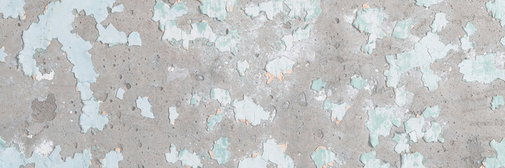 Peeling paint on the wall. Old concrete wall with cracked flaking paint. Weathered rough painted surface with patterns of cracks and peeling. Grunge texture for background and design. High resolution.