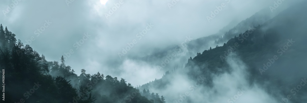 Poster an enchanting view of a distant mountain forest covered in low-lying clouds, giving a mystical and s