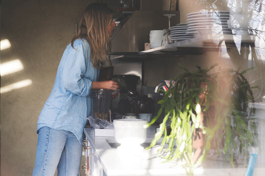 Healthy Kitchen - woman prepares healthy food in her summer kitchen