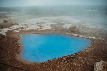 Geyser blue hot pond in the Golden Circle, Iceland, steamy landscape