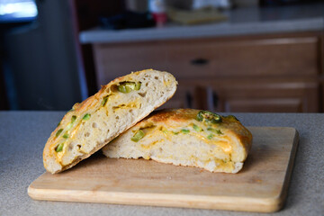 Sliced jalapeño cheese bread loaf showing a cross-section on a