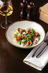 salad with vegetables and cod liver. restaurant menu
