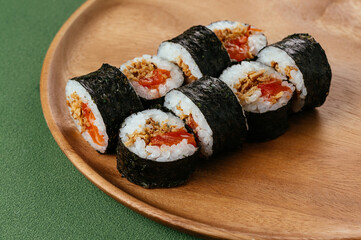 Japanese sushi roll with salmon on a wooden plate